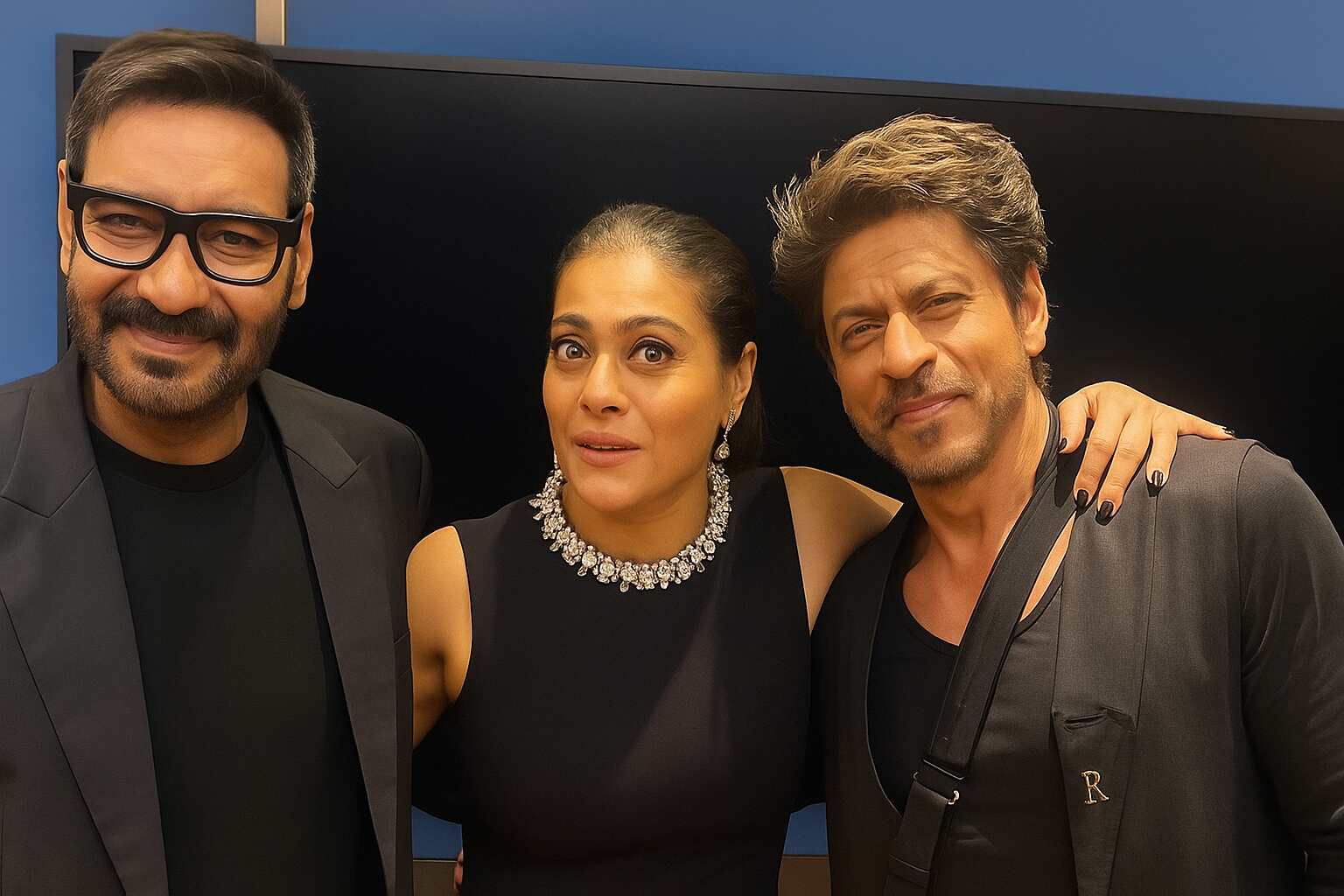 Kajol sandwiched between Shah Rukh Khan and Ajay Devgn at Bollywood premiere